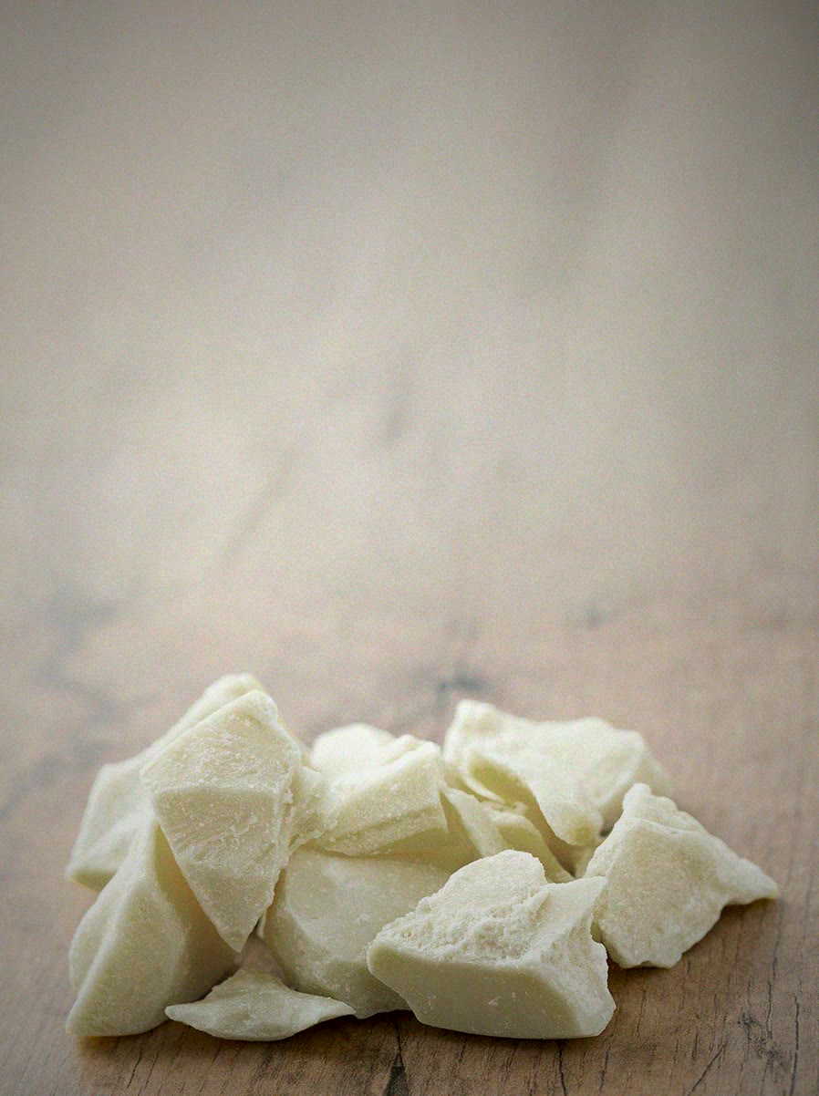 Pieces of plant-based fat on a wooden surface